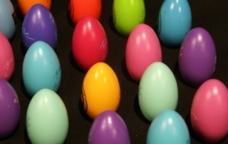 Assorted painted wooden eggs, available in bulk for manufacturers and large-scale production runs.